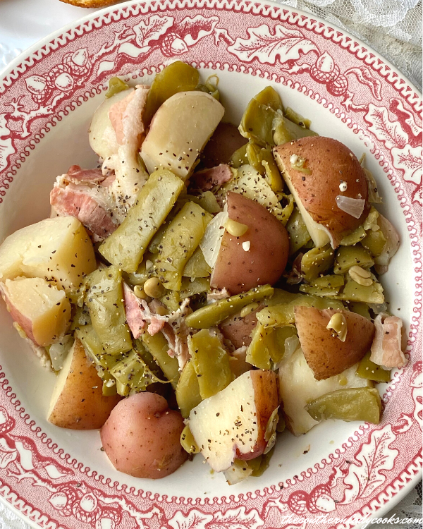 Southern green beans and potatoes in a red bowl