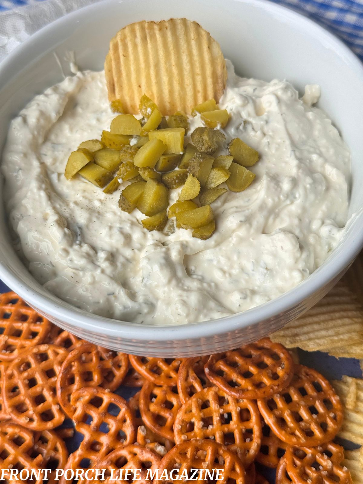 creamy dill pickle dip in a white serving bowl