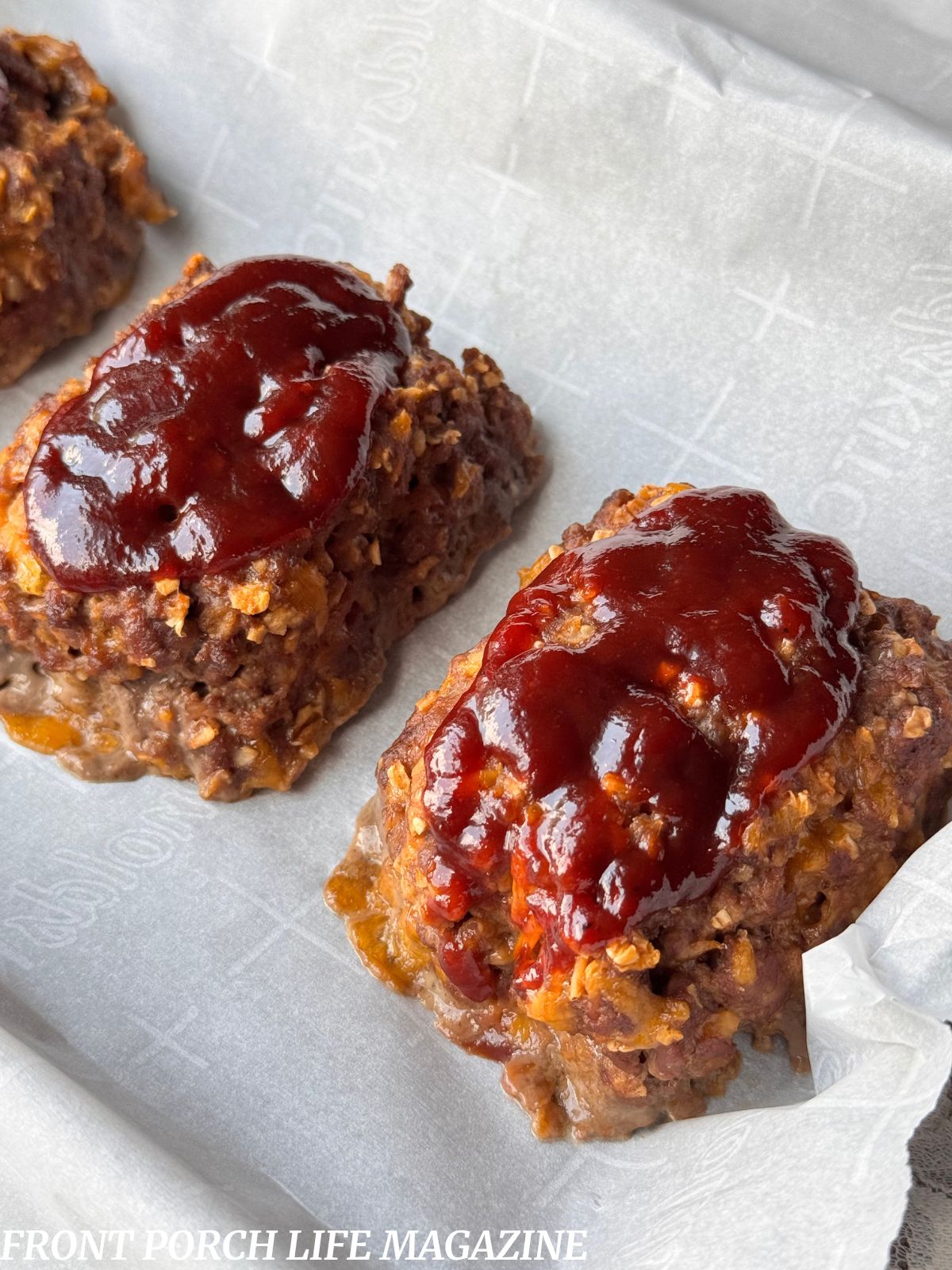 Mini bbq cheddar meatloaves on parchment paper