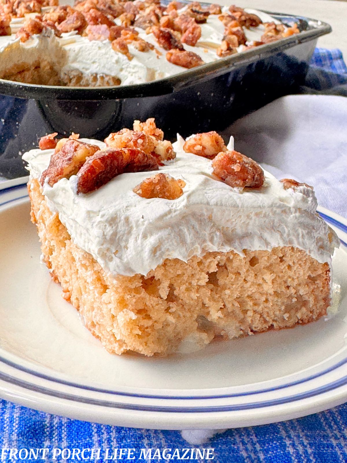 A slice of apple praline poke cake on a white and blue plate