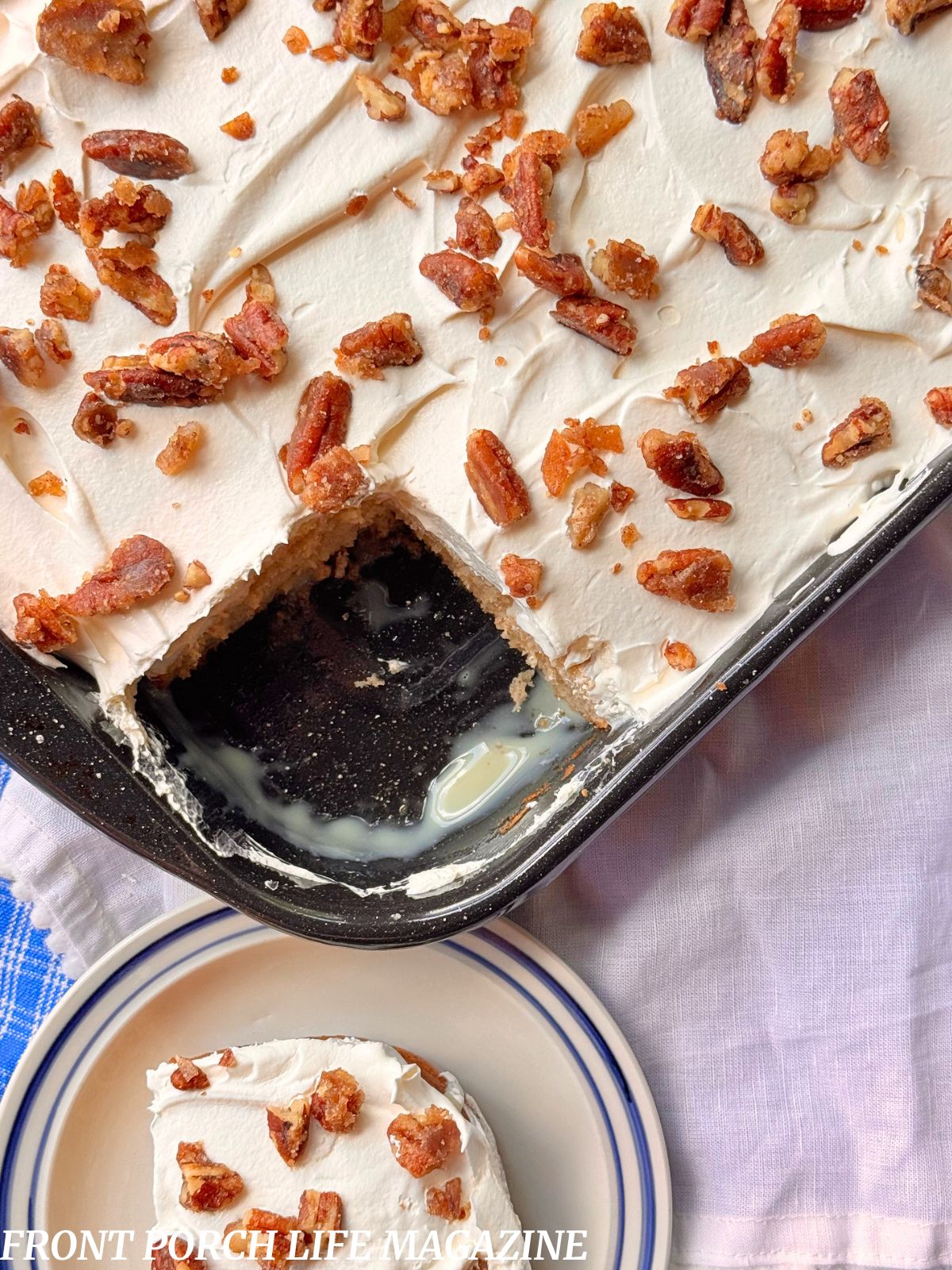 Apple praline poke cake in a pan with a slice