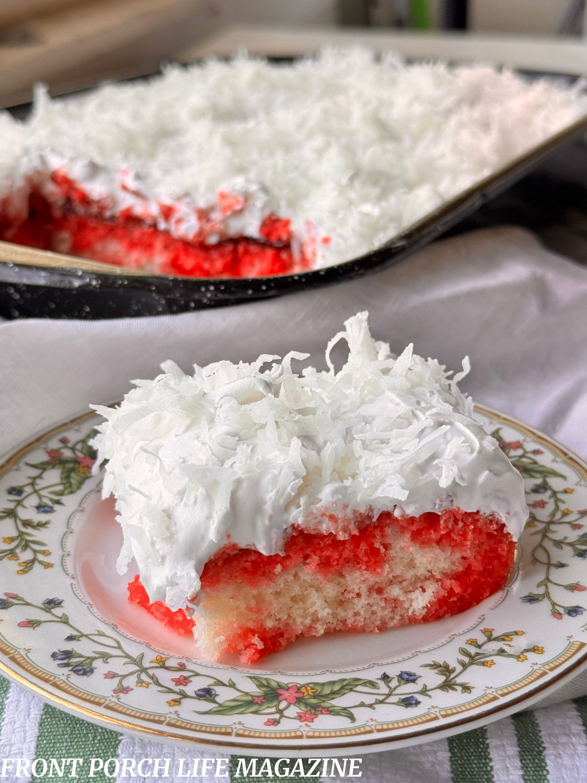 Raspberry Zinger Poke Cake a slice on a plate